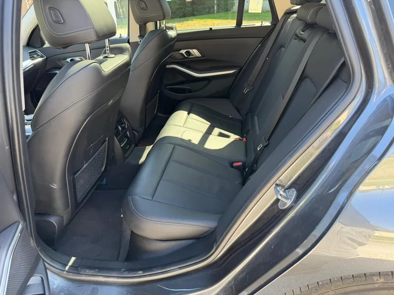 Intérieur arrière BMW 320e — banquette cuir pour trajets confortables